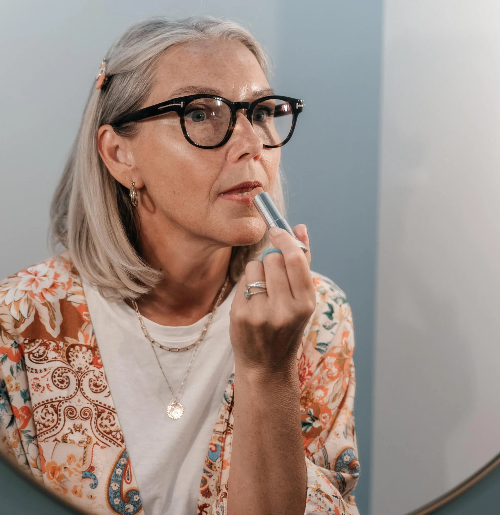 Old woman applying lipstick | Femme Moderne Center for Aesthetics in Draper, Utah