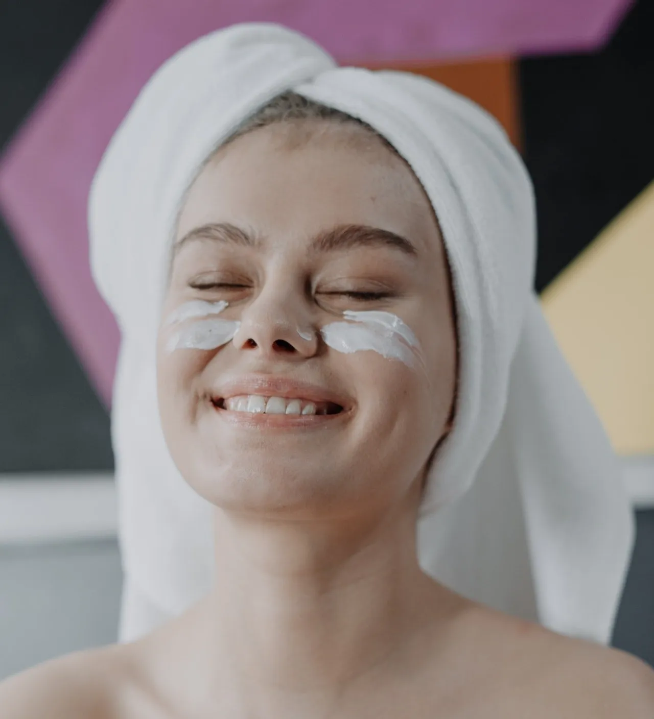 Smiling woman applied cream on Under eye area | Femme Moderne Center for Aesthetics in Draper, UT