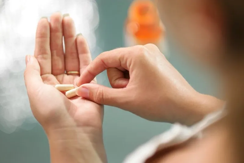A Women having Vitamins | Femme Moderne Center for Aesthetics in Draper, Utah