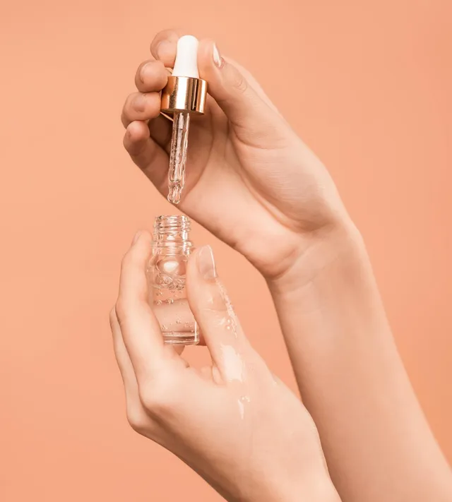 woman holding face serum | Femme Moderne Center for Aesthetics in Draper, Utah